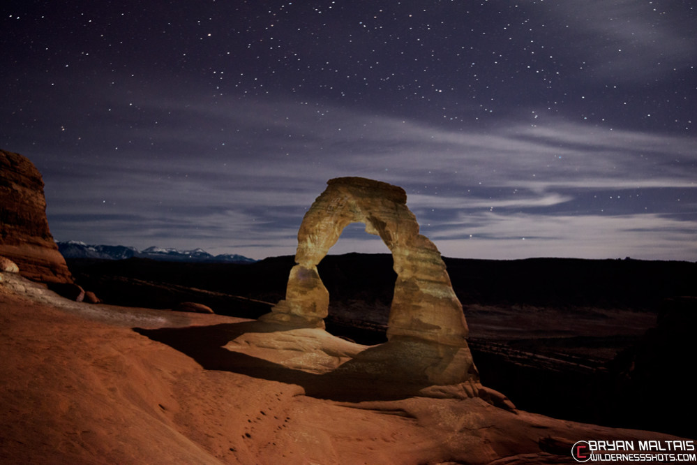 Delicate Arch at night with a bright moon